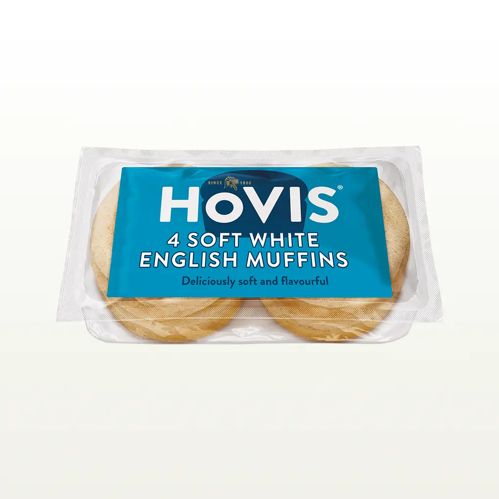 Four Hovis Soft White Muffins stacked in two piles of two inside a transparent rectangular packaging with a blue label..