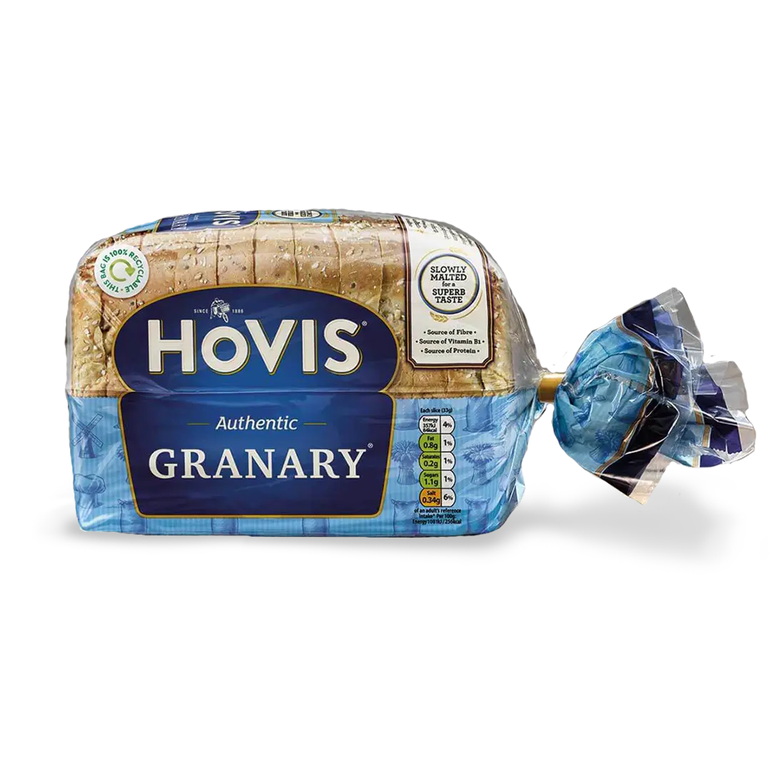 Hovis Granary 400g bread on a white backdrop with a subtle shadow. The packaging is half transparent and half blue, decorated with images of mills, flour and wheat.
