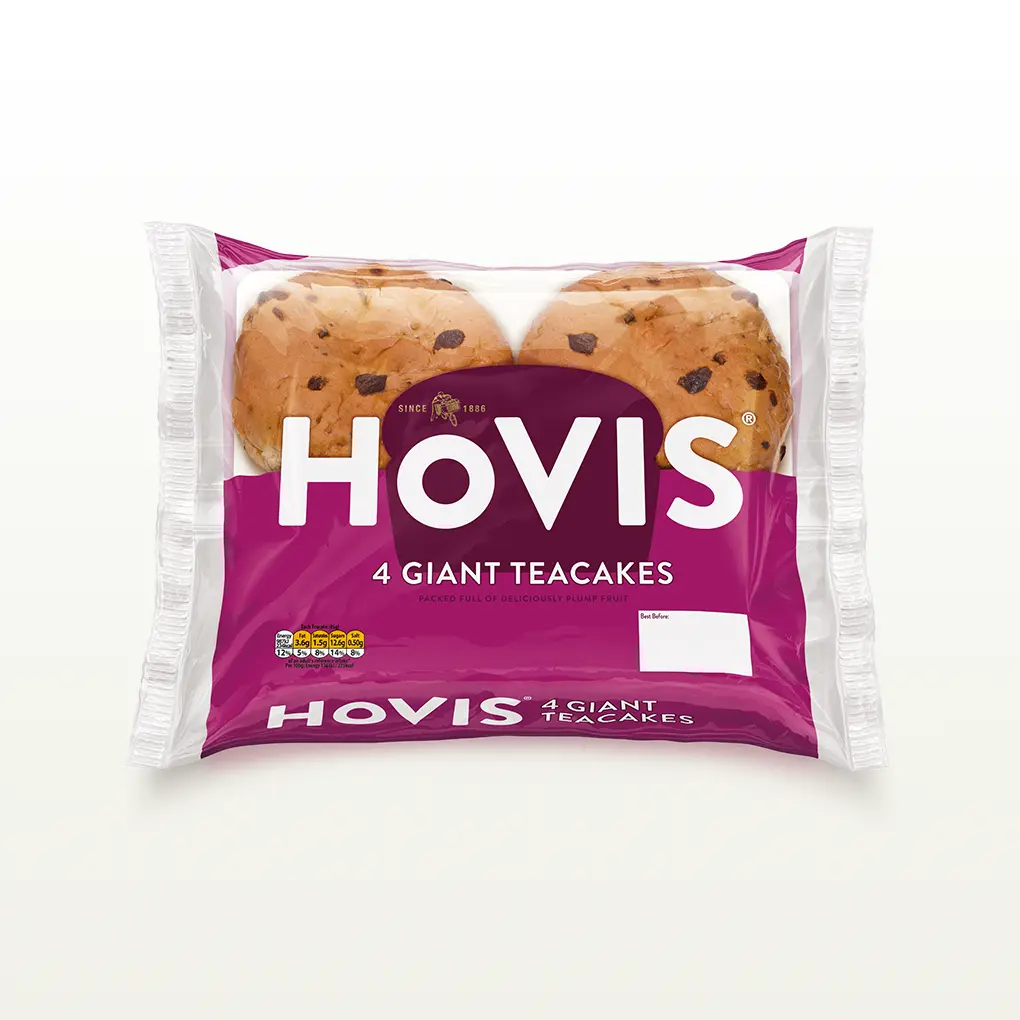 Four Hovis 4  Teacakes in a transparent square packaging featuring the Boy on the Bike, a magenta stripe, and the Hovis logo on the back.