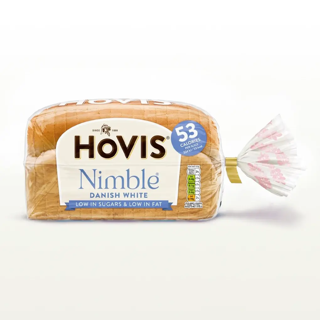 Hovis Nimble Danish White bread on a white backdrop with a subtle shadow. The packaging is transparent, decorated with pink wheats, and a light blue label that reads '53 calories per slice'