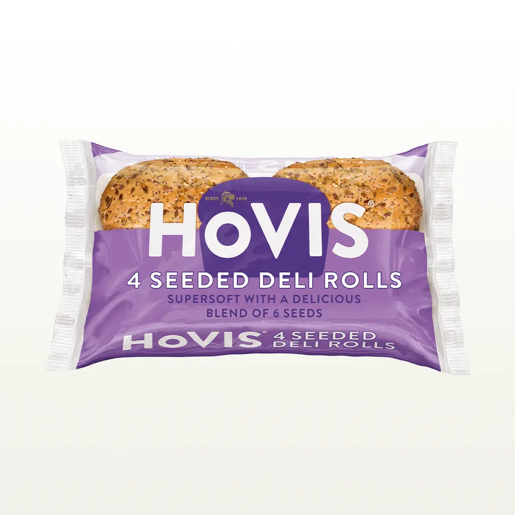 Four Hovis 4 Seeded Deli Rolls in a half transparent, half light purple rectangular packaging featuring the Hovis loaf shape in darker purple and logo in white
